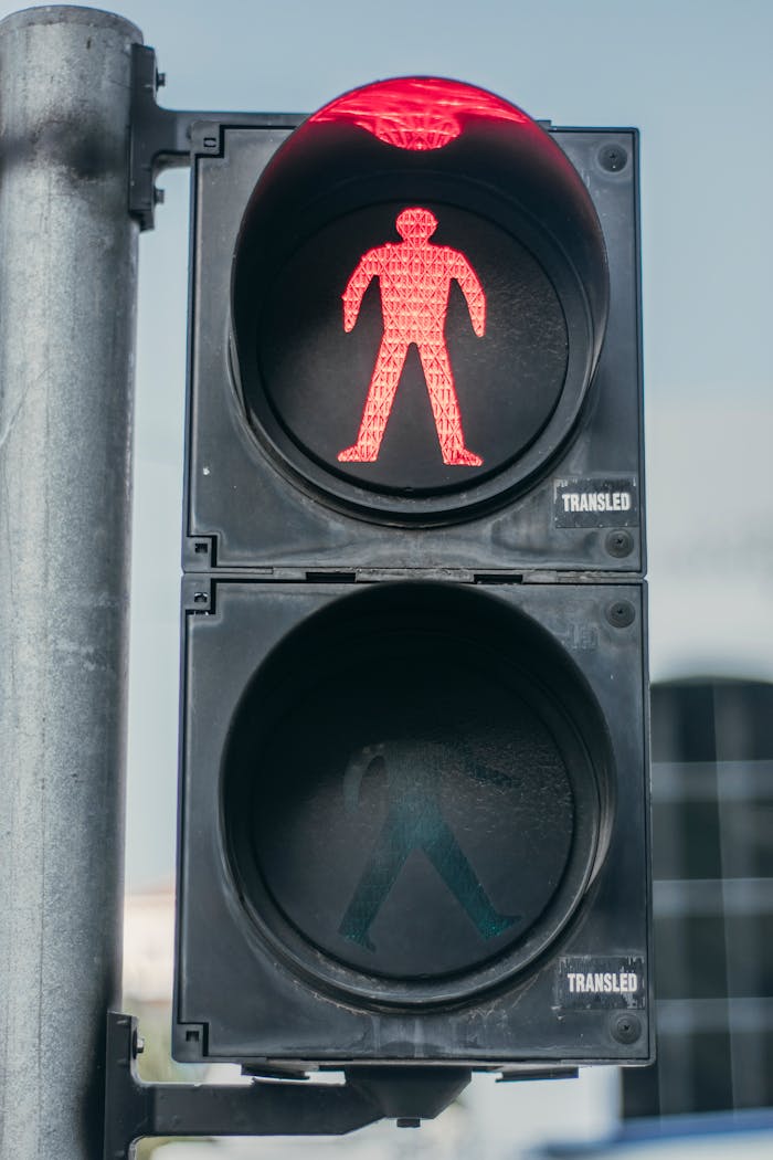 Close-up of a red pedestrian traffic light signal indicating stop for walkers.